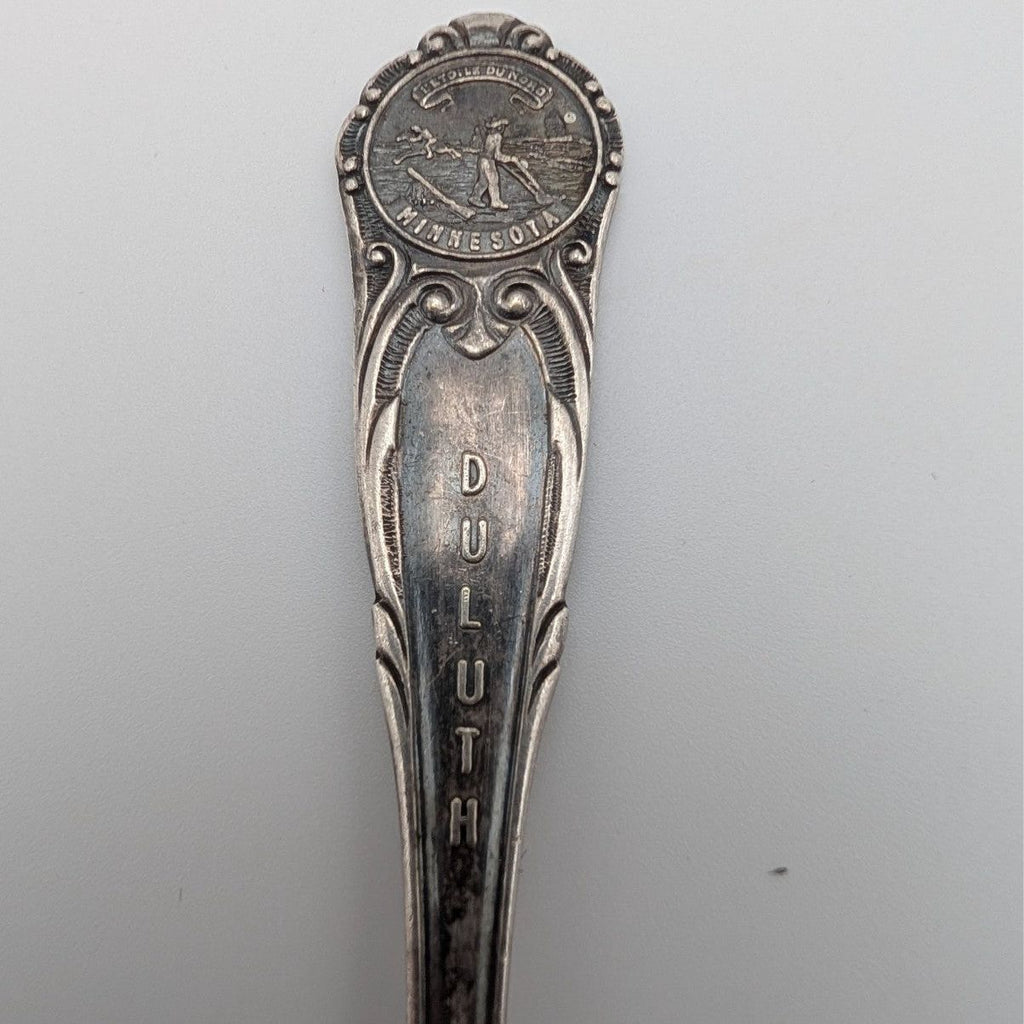 Silver-plated souvenir spoon with Minnesota medallion and ornate handle