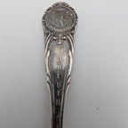 Silver-plated souvenir spoon with Minnesota medallion and ornate handle
