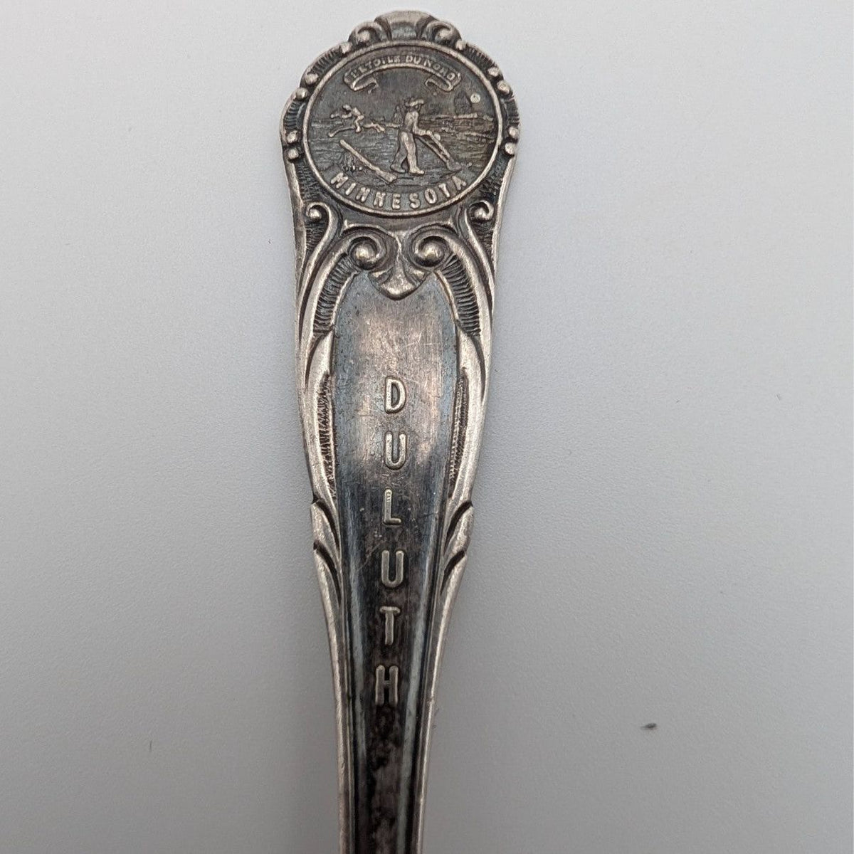 Silver-plated souvenir spoon with Minnesota medallion and ornate handle