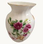 White bone china vase with purple pink flowers, green leaves, and gold rim