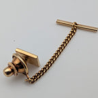 Gold-tone tie tack pin with bar post, retaining chain, and t-bar locking piece