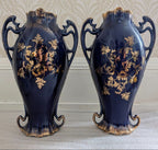 Pair of cobalt blue porcelain vases with ornate handles and gold floral medallion, Sevres-style