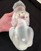 Frosted crystal cat sculpture, underside view held in hand with stamped marks