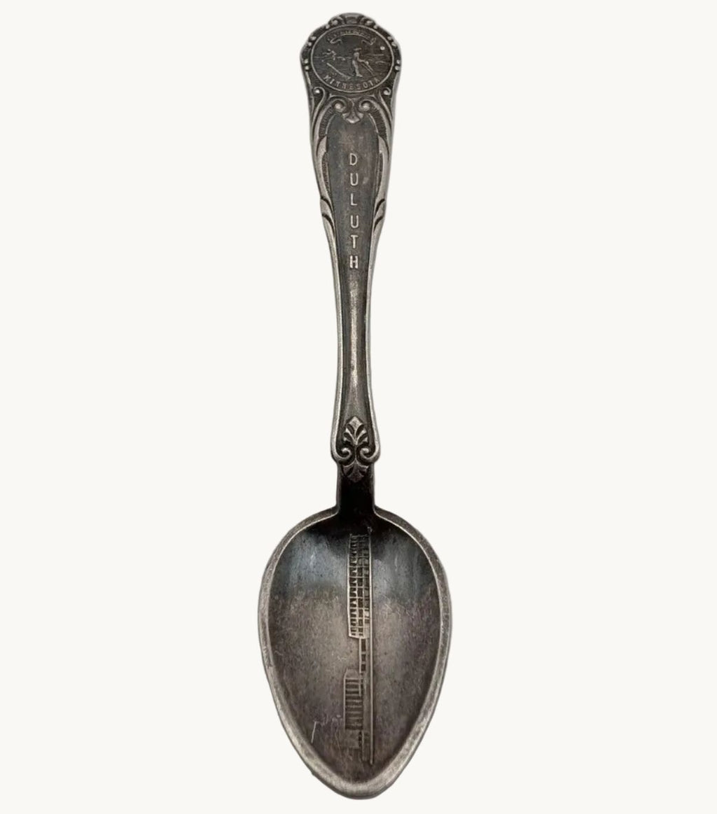 Silver-plated souvenir spoon with oval bowl, Duluth lettering and ornate handle