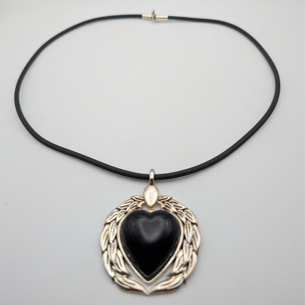 Black heart pendant necklace with silver-tone wreath frame and dark cord