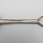 Engraved handle of shovel-shaped collector spoon marked “FORT INC 1980”