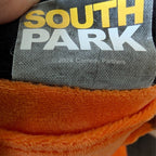 South Park licensed plush tag on orange fabric, shows 2024 Comedy Partners text