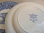 White porcelain plate bottom with Spode mark and 'Warwick Vase' text in blue.