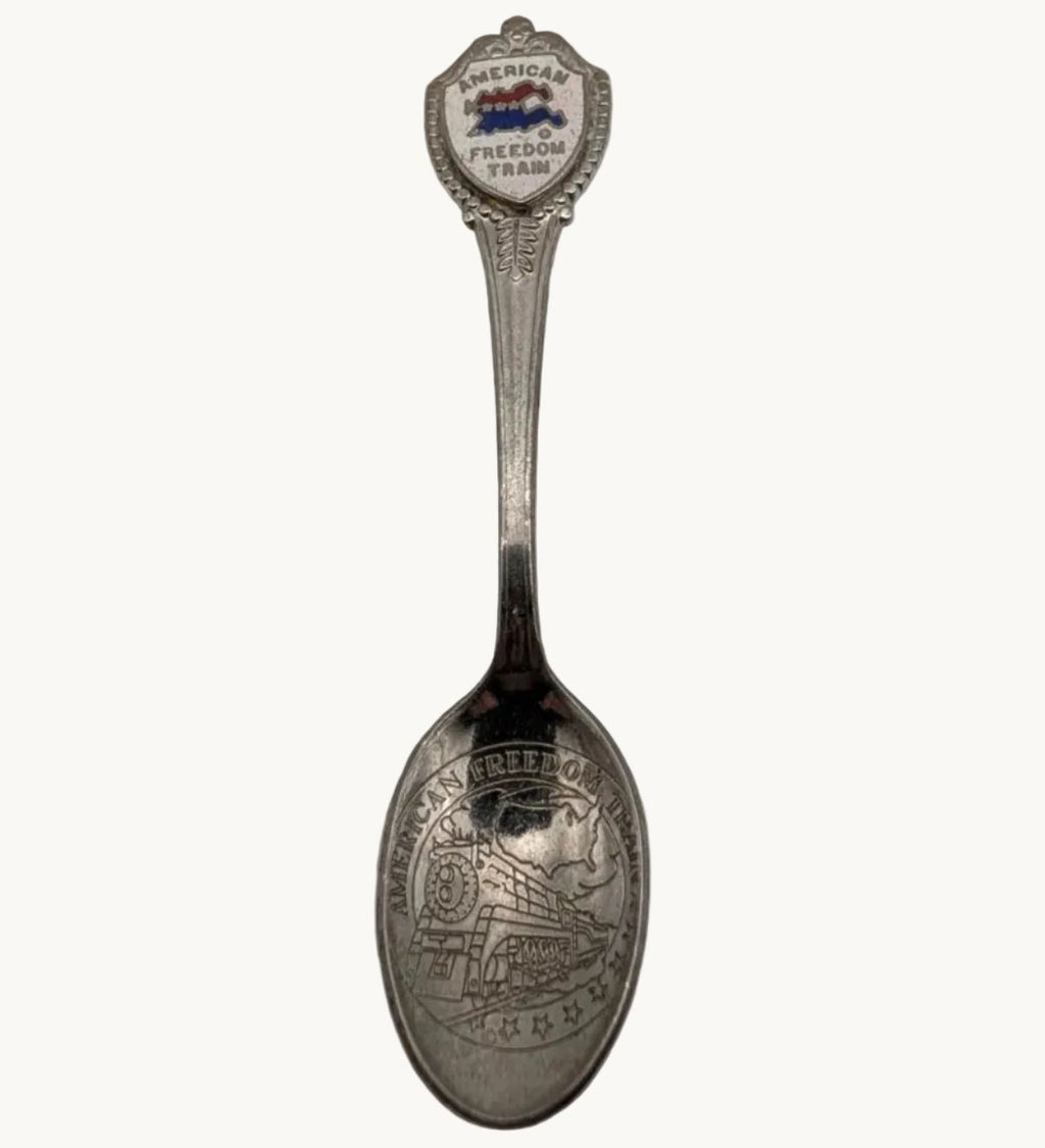 Souvenir collector spoon with round Freedom Train emblem and engraved handle