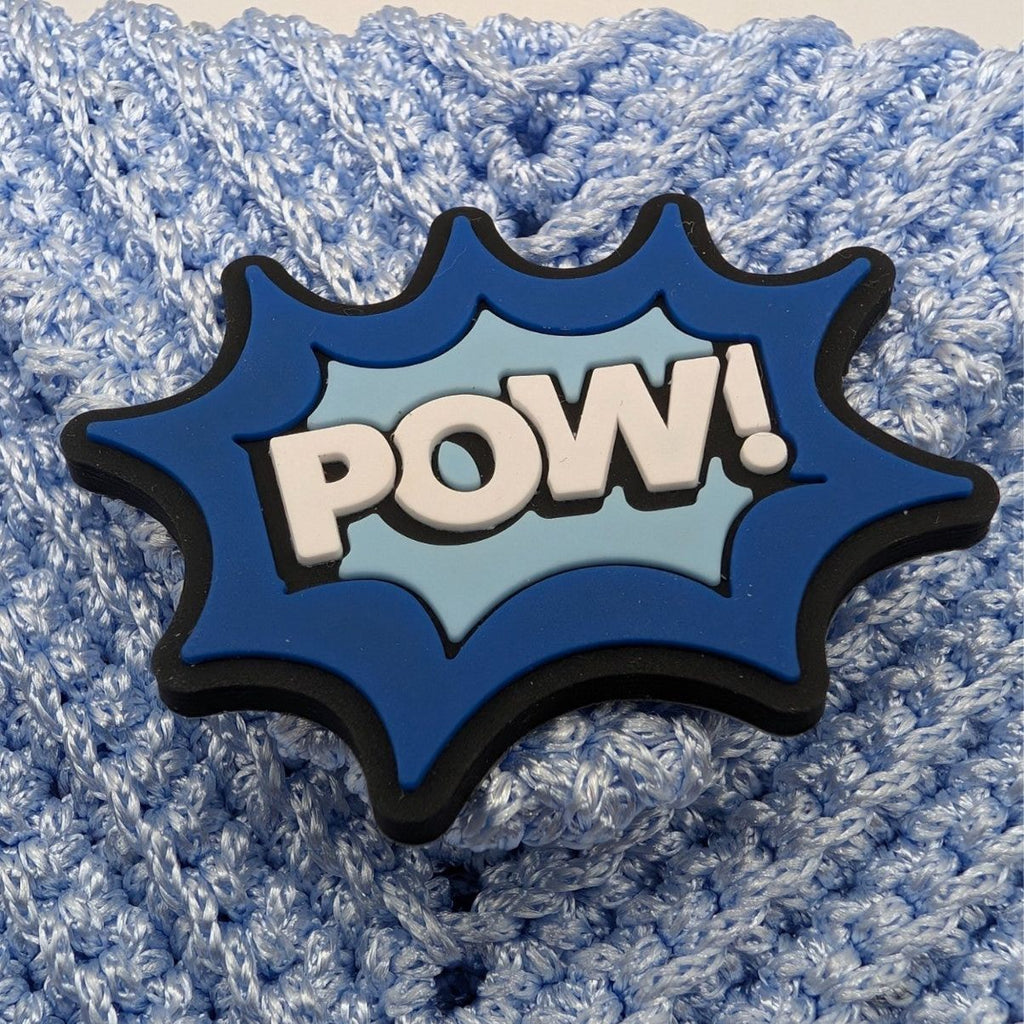 Light blue crochet phone bag with large POW comic-style patch on front