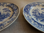 Blue-and-white dinner plates with floral border and girl at well blue scene