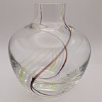 Clear glass bud vase with internal swirl and curved neck opening