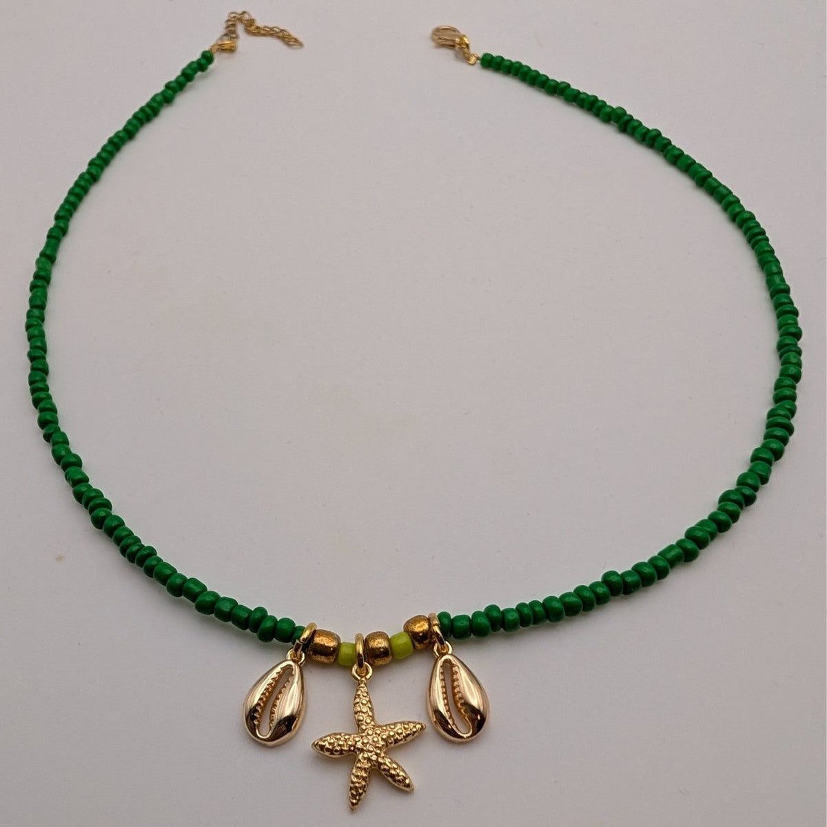 Green beaded choker necklace with starfish charm and shell dangles