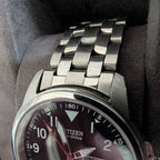Military style watch dial close-up, Citizen Eco-Drive text with red accents