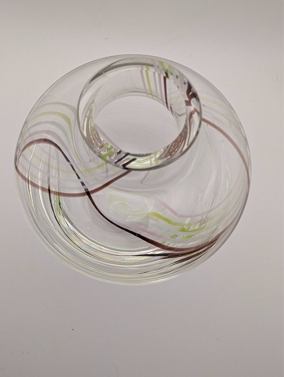 Clear glass bud vase with internal swirl detail around top opening