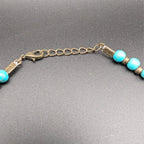 Bronze chain clasp with turquoise bead ends on multi-strand beaded choker