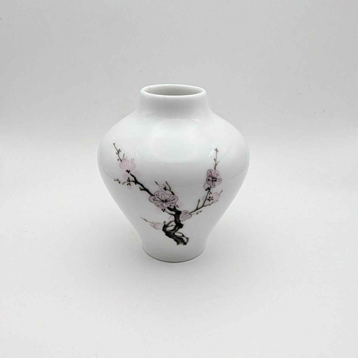 Porcelain bud vase, white with pink cherry blossom and tree-branch design