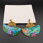 Hand-painted wooden half-moon drop earrings with colorful floral pattern and gold hardware