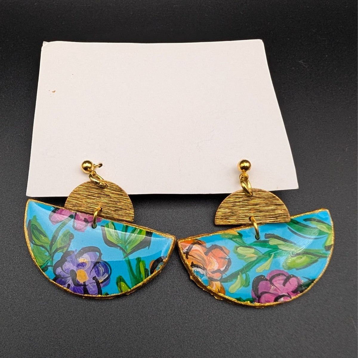 Hand-painted wooden half-moon drop earrings with colorful floral pattern and gold hardware