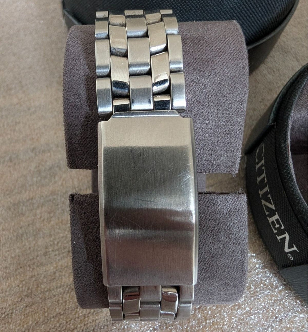 Military style watch bracelet and clasp close-up with steel link band