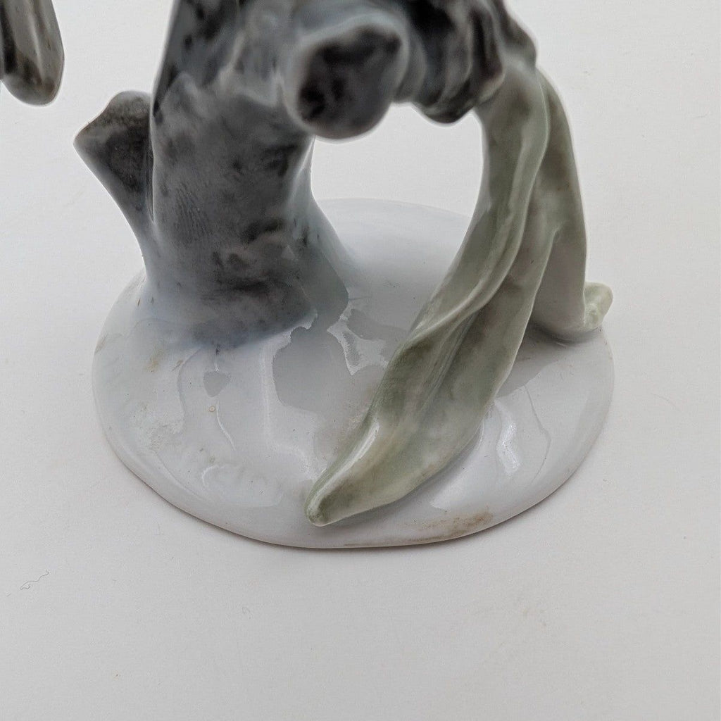 Hand-painted porcelain robin figurine on white oval base, gray body with tail and curled wing