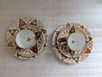 Porcelain cups and saucers, top view, ornate geometric border and floral accents