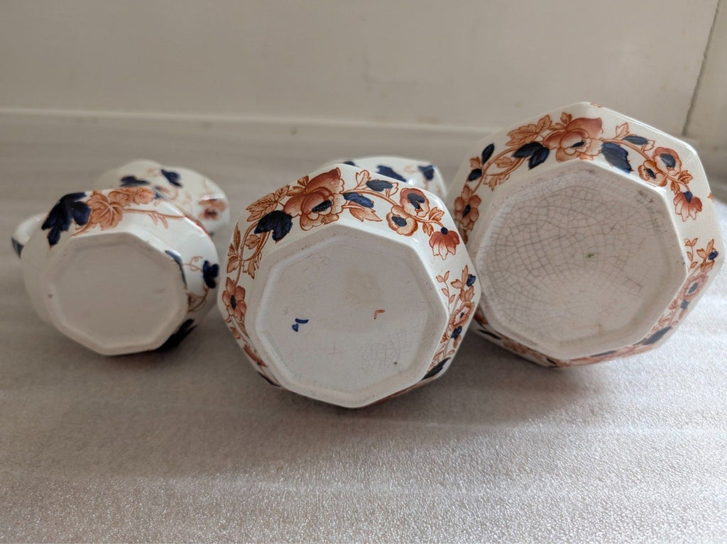 Set of 3 ironstone hydra jugs, underside views with blue and terracotta floral decor