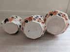 Set of 3 ironstone hydra jugs, underside views with blue and terracotta floral decor