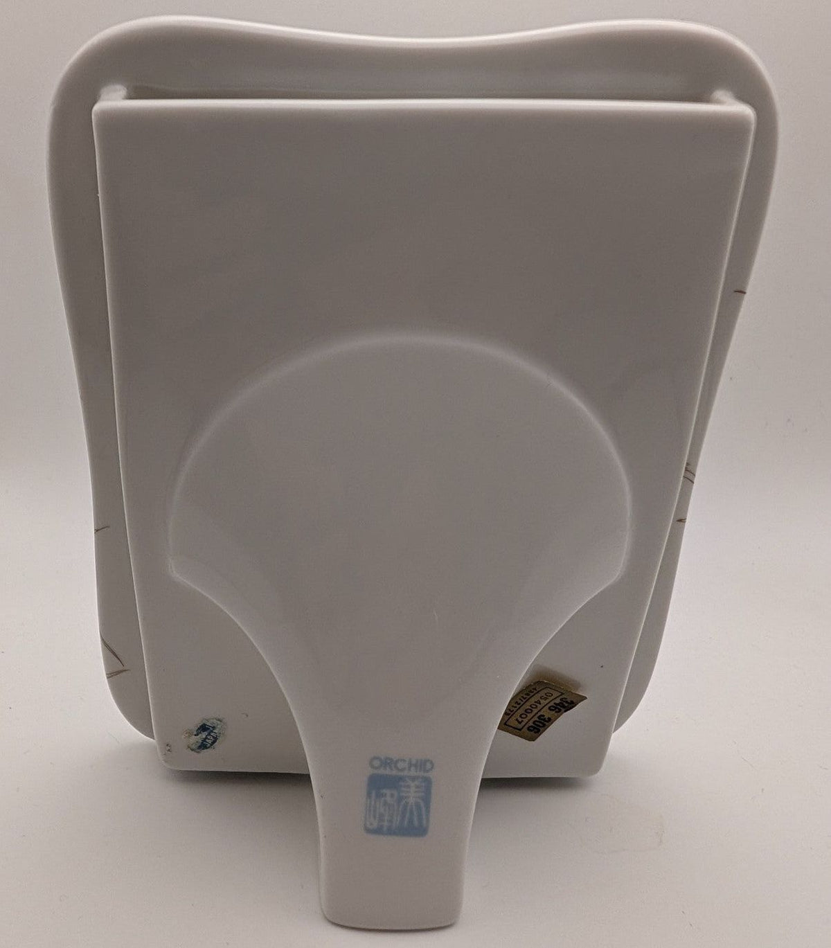 White standing porcelain photo frame with blue ORCHID label on back
