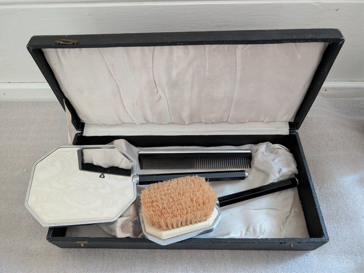 Blue octagonal mirror, brush, and comb in hinged display box