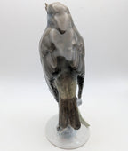 Hand-painted porcelain robin bird figurine from behind, gray feathers with orange tail patch on base