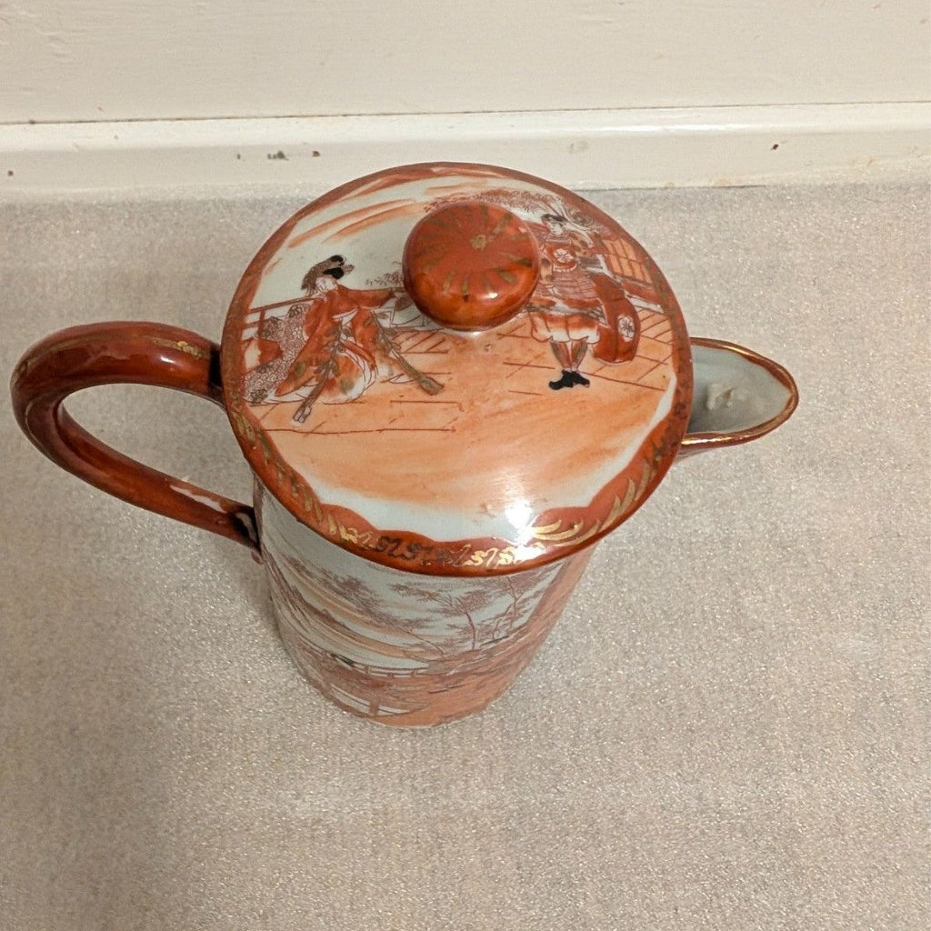 Hand-painted porcelain coffee pot with lid, orange knob, village scene on lid