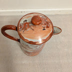 Hand-painted porcelain coffee pot with lid, orange knob, village scene on lid