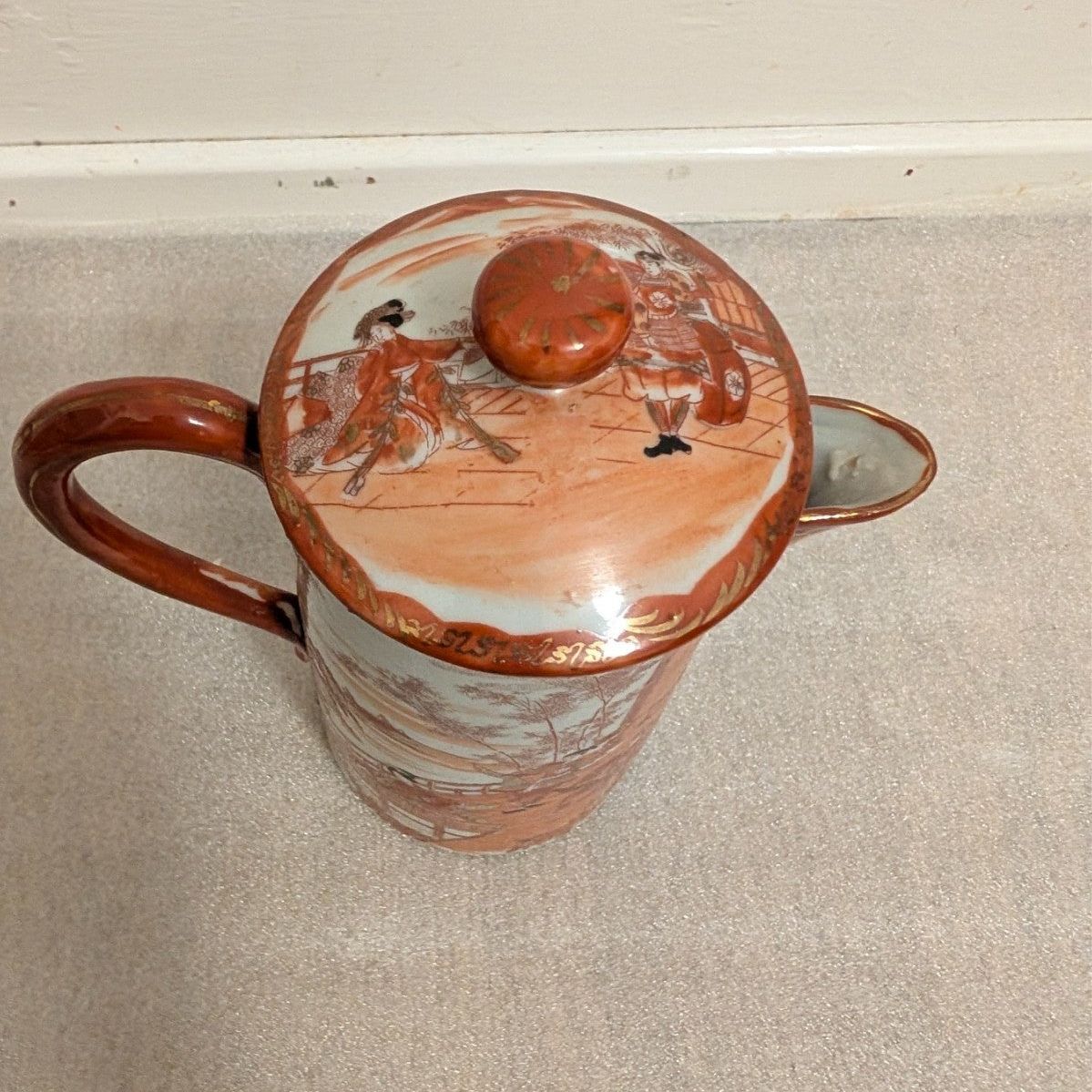 Hand-painted porcelain coffee pot with lid, orange knob, village scene on lid