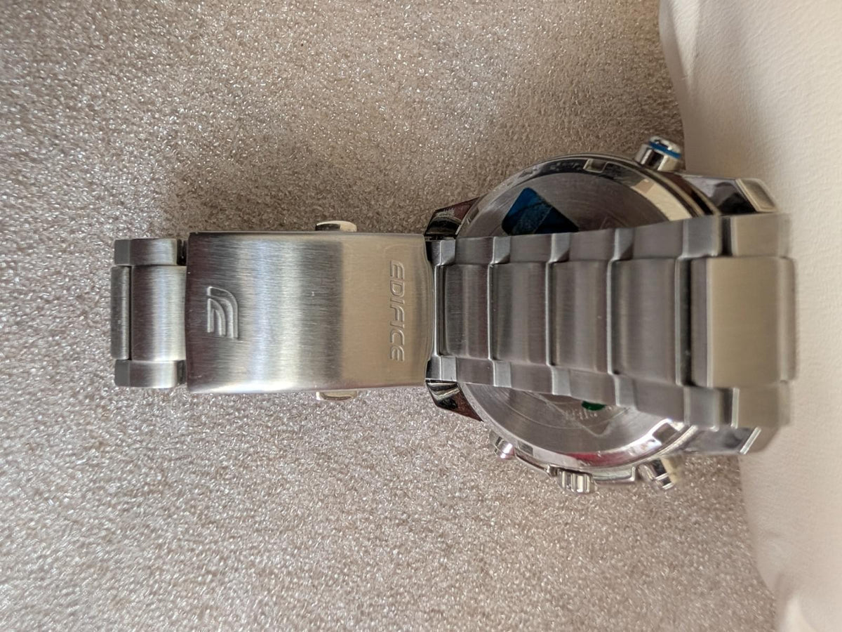 Stainless steel watch case underside with bracelet links and metal clasp detail
