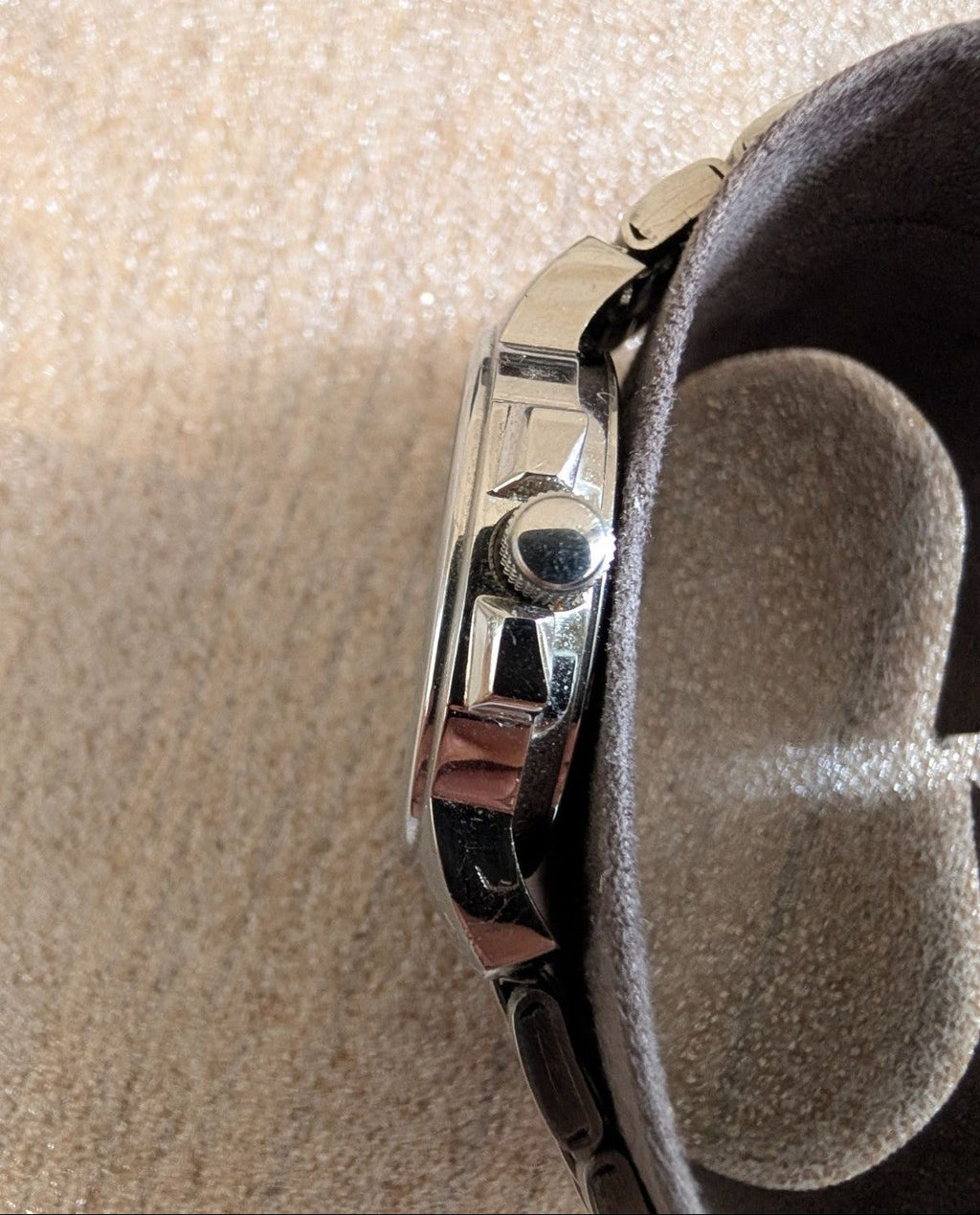 Military style watch back side close-up, polished case detail and crown
