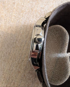 Military style watch back side close-up, polished case detail and crown