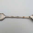 Silver collector spoon handle with banded grip and gold-toned edge