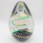 Teardrop glass paperweight with green and gold spiral, 12cm