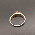 Gold tone solitaire costume ring with small clear rhinestone top view
