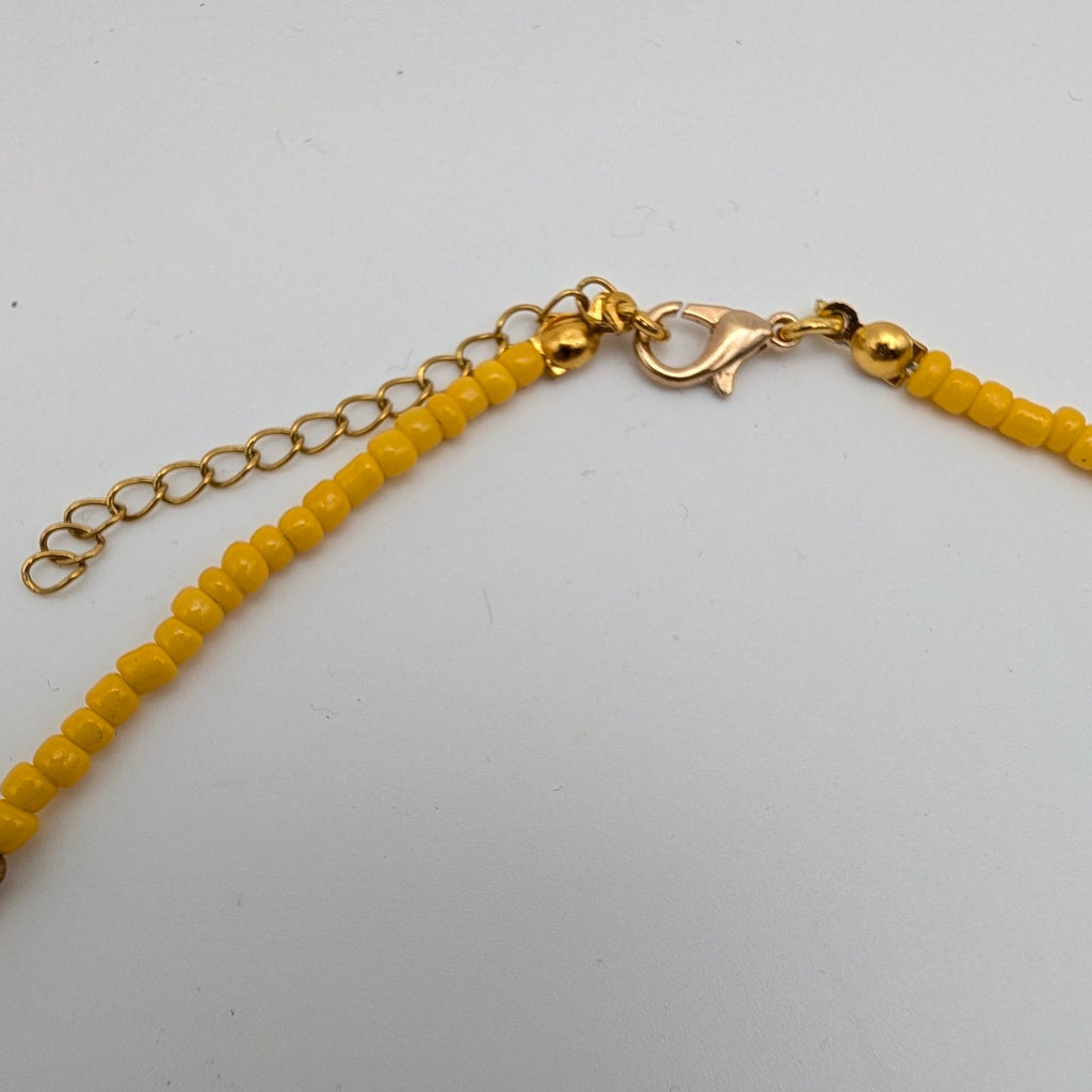 Yellow beaded choker with gold-tone chain and spring-ring clasp