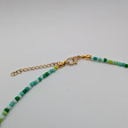 Gold-tone lobster clasp and extender chain on handmade multicolour seed bead necklace