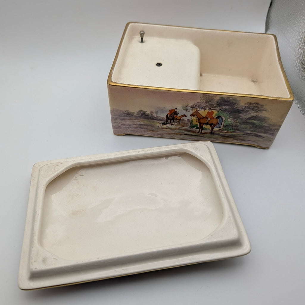 Underside of removable ceramic lid and interior of Crown Devon music box