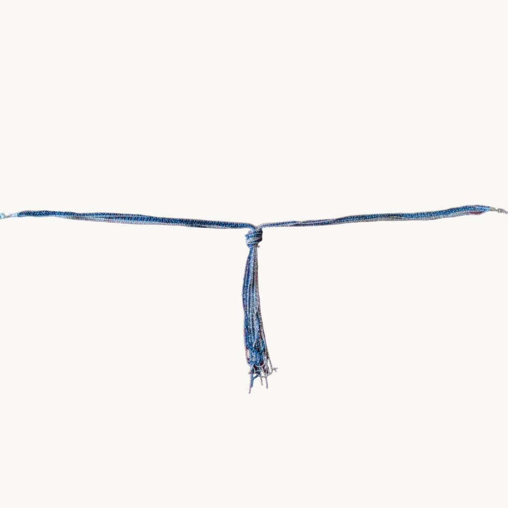 Full length view of navy blue and silver-tone lariat tassel necklace
