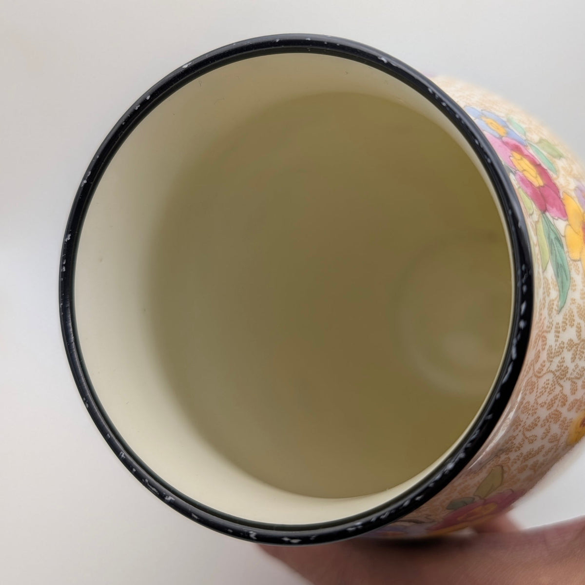 Close-up showing paint loss around the dark rim of the Royal Doulton vase